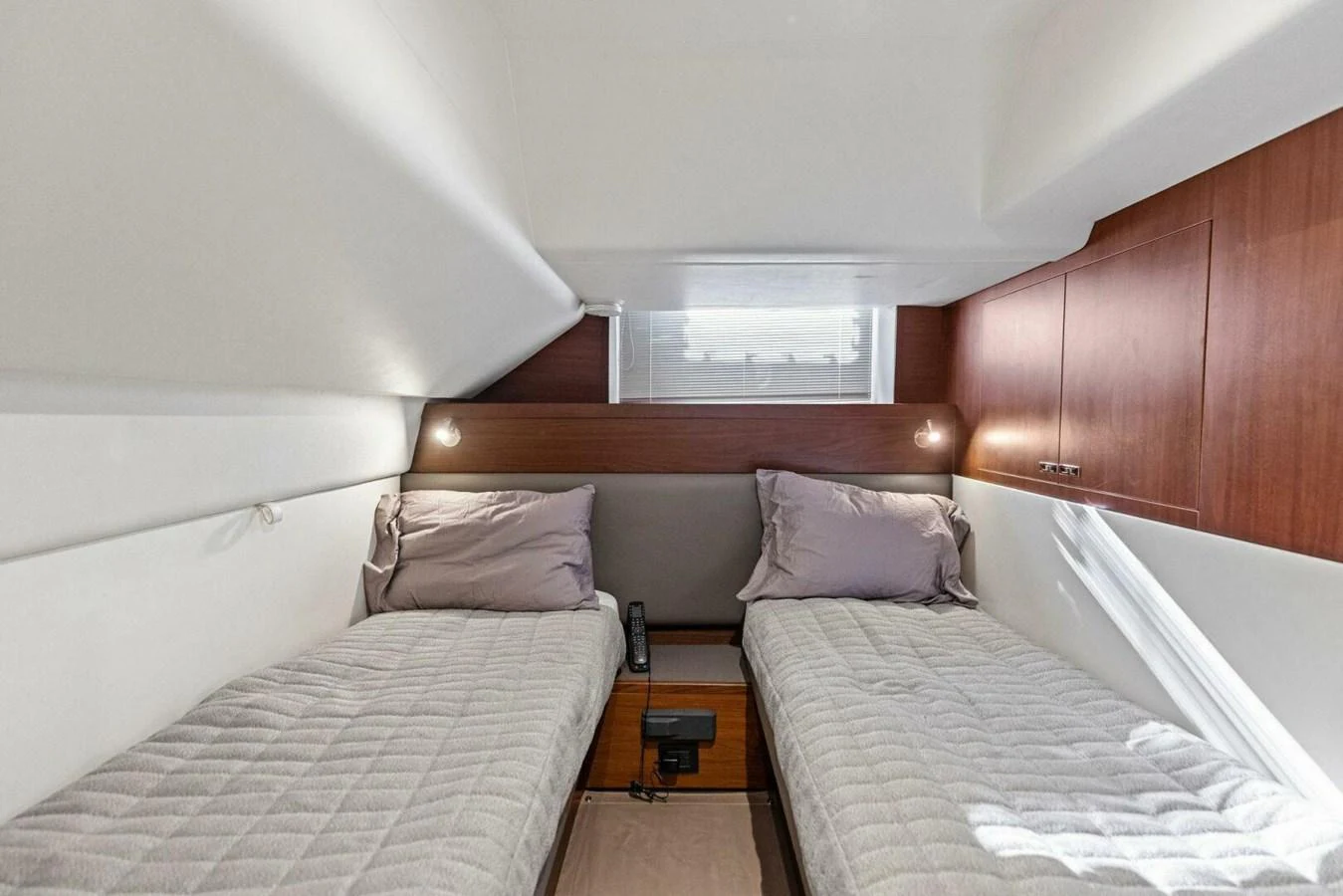 The twin stateroom offers a cozy and modern sleeping area with two single beds and ambient lighting. aboard 3BBOYS Yacht for Sale