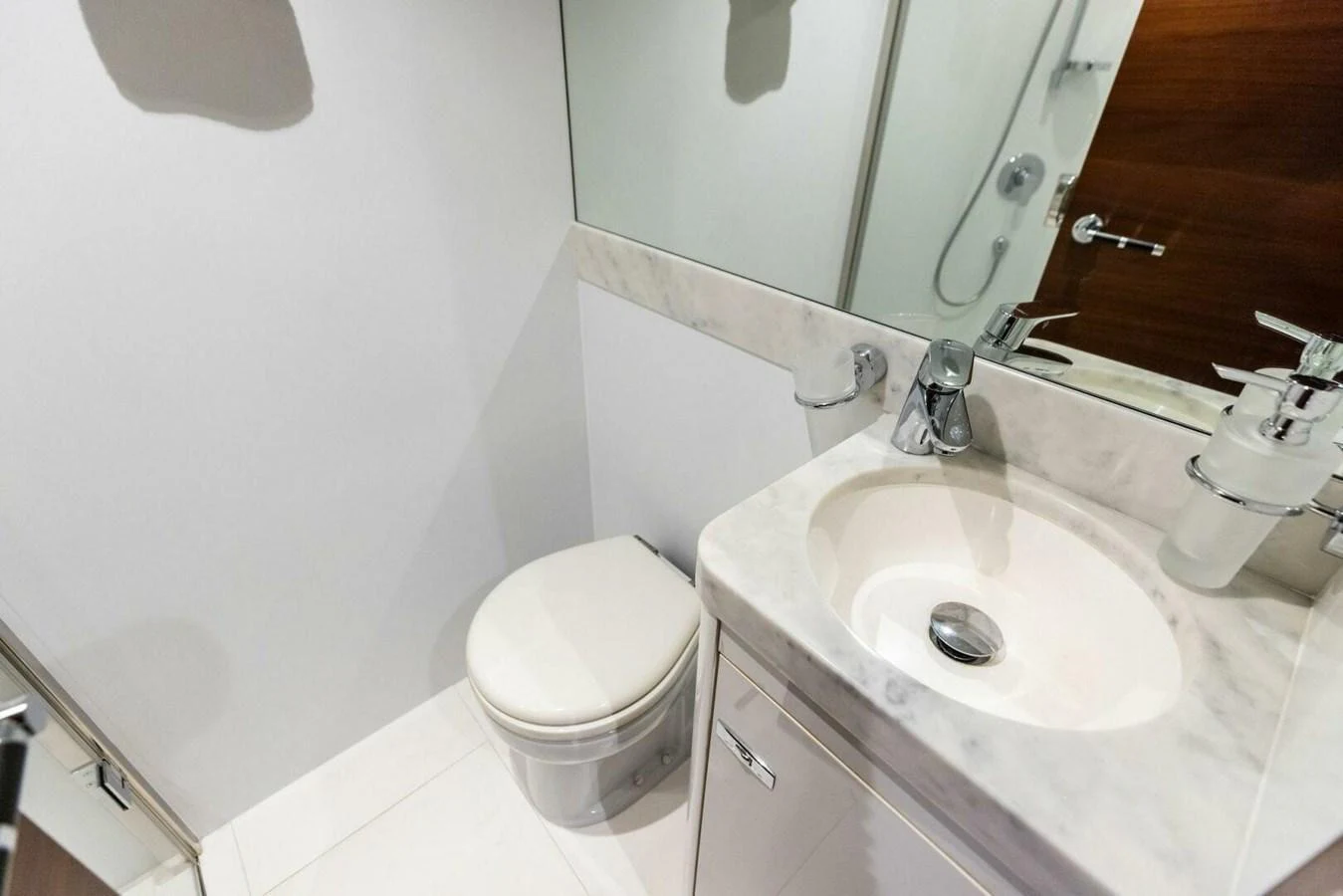 The yacht's bathroom features a sleek design with a modern sink and toilet. aboard 3BBOYS Yacht for Sale