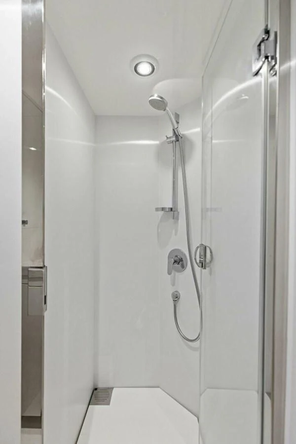 The yacht features a sleek and modern shower area with clean lines and contemporary fixtures. aboard 3BBOYS Yacht for Sale