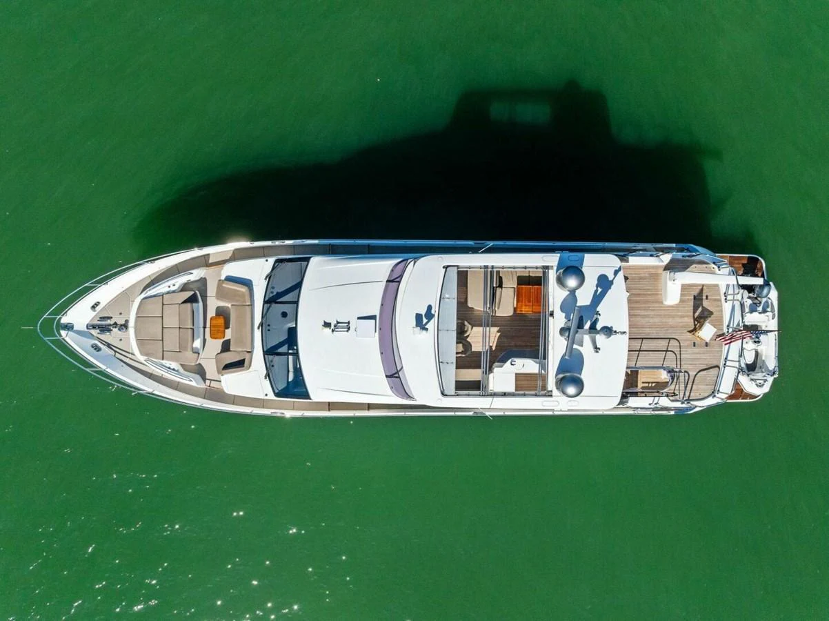Aerial view of a sleek yacht cruising on calm green waters. aboard 3BBOYS Yacht for Sale
