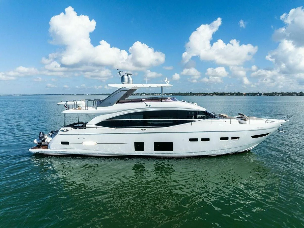 A sleek and modern yacht cruising on calm waters under a bright blue sky. aboard 3BBOYS Yacht for Sale