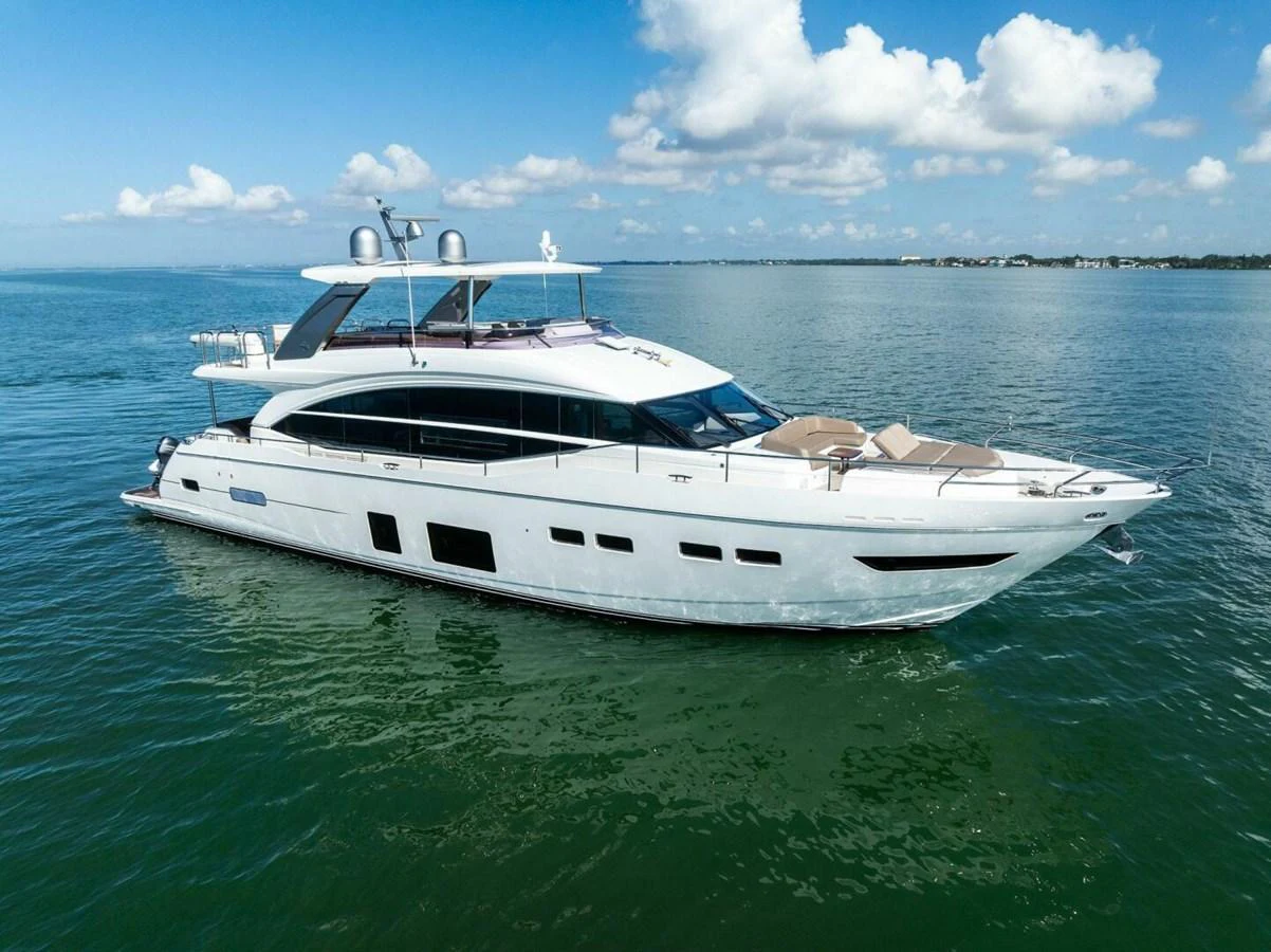 A sleek and modern yacht cruising on calm waters under a clear blue sky. aboard 3BBOYS Yacht for Sale
