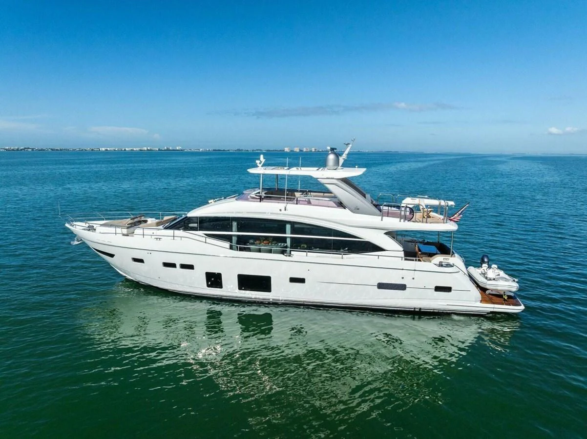 A sleek and modern yacht glides gracefully on calm waters under a clear blue sky. aboard 3BBOYS Yacht for Sale