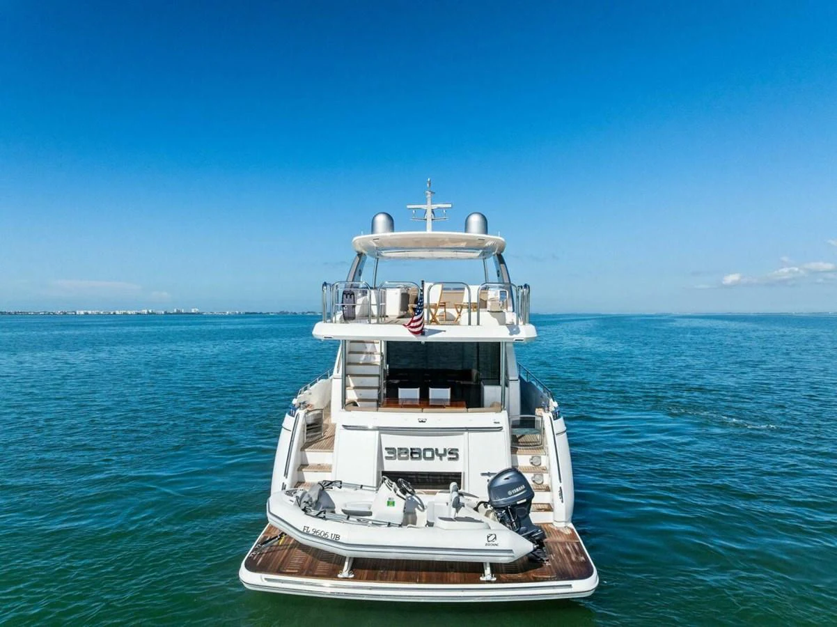 The yacht's aft deck is showcased against a serene ocean backdrop, highlighting its spacious and inviting design. aboard 3BBOYS Yacht for Sale