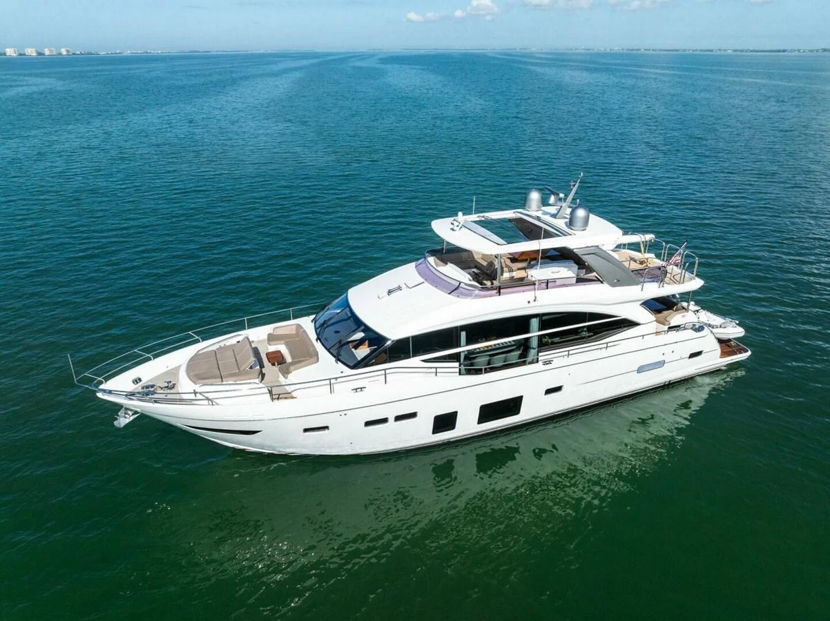 A sleek and modern yacht cruising on calm waters under a clear blue sky. aboard 3BBOYS Yacht for Sale