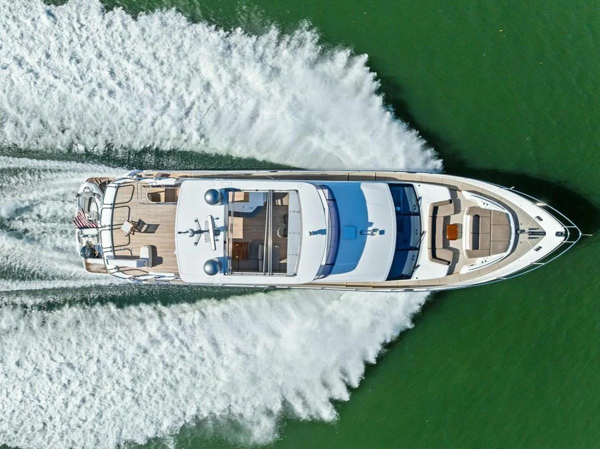 An aerial view of a luxurious yacht cruising through the water, showcasing its sleek design and spacious deck areas. aboard 3BBOYS Yacht for Sale