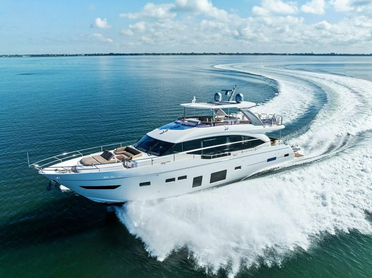 A sleek and modern yacht cruises swiftly through the open water, leaving a trail of white waves behind. aboard 3BBOYS Yacht for Sale