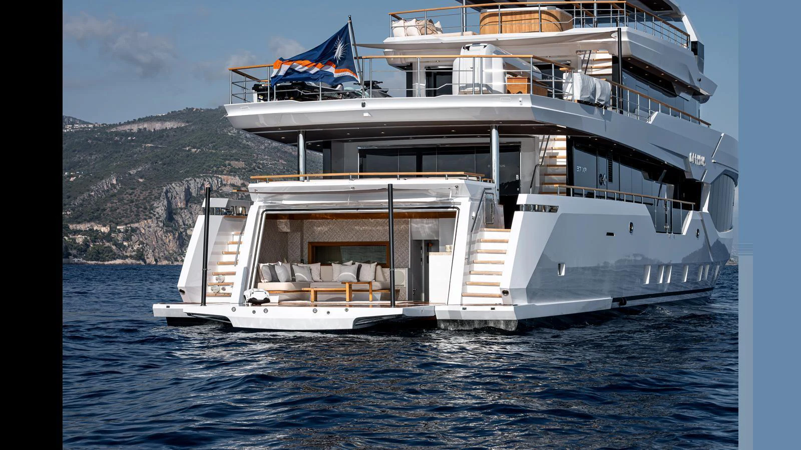 The yacht's aft deck features a luxurious lounging area with direct access to the water. aboard NUMARINE 37XP-21 Yacht for Sale
