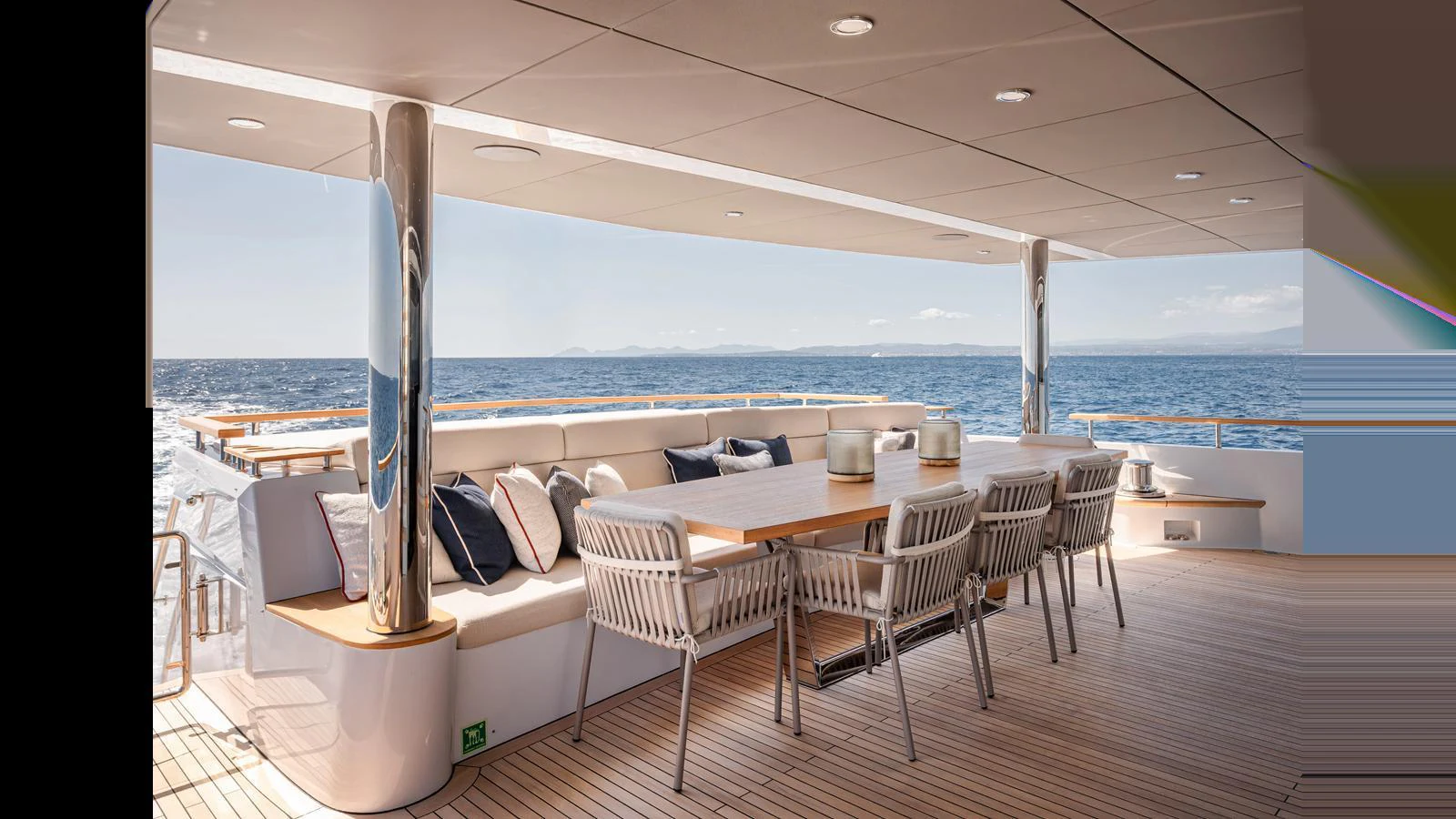 The aft deck features a spacious seating area with a dining table, offering stunning ocean views. aboard NUMARINE 37XP-21 Yacht for Sale