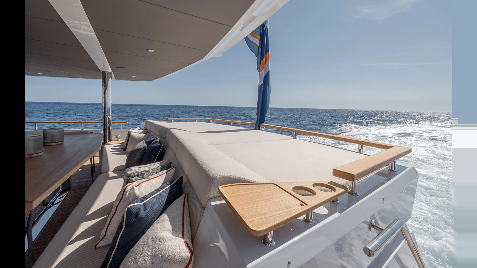 The aft deck offers a luxurious lounging area with plush seating and a view of the open sea. aboard NUMARINE 37XP-21 Yacht for Sale