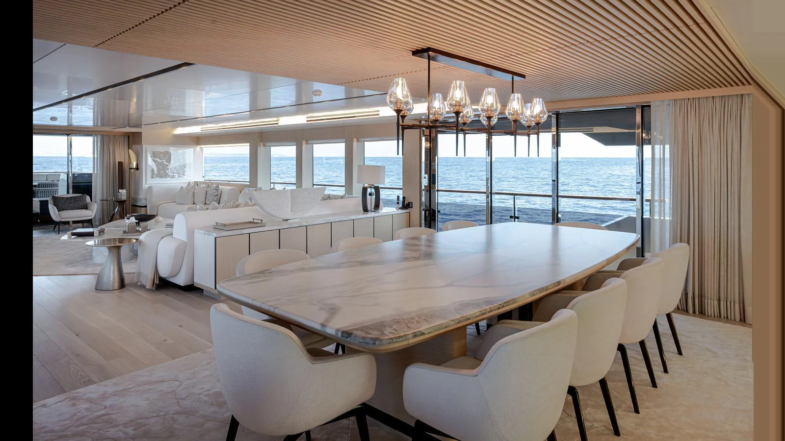 The yacht's dining area features a luxurious table with comfortable seating and expansive ocean views. aboard NUMARINE 37XP-21 Yacht for Sale