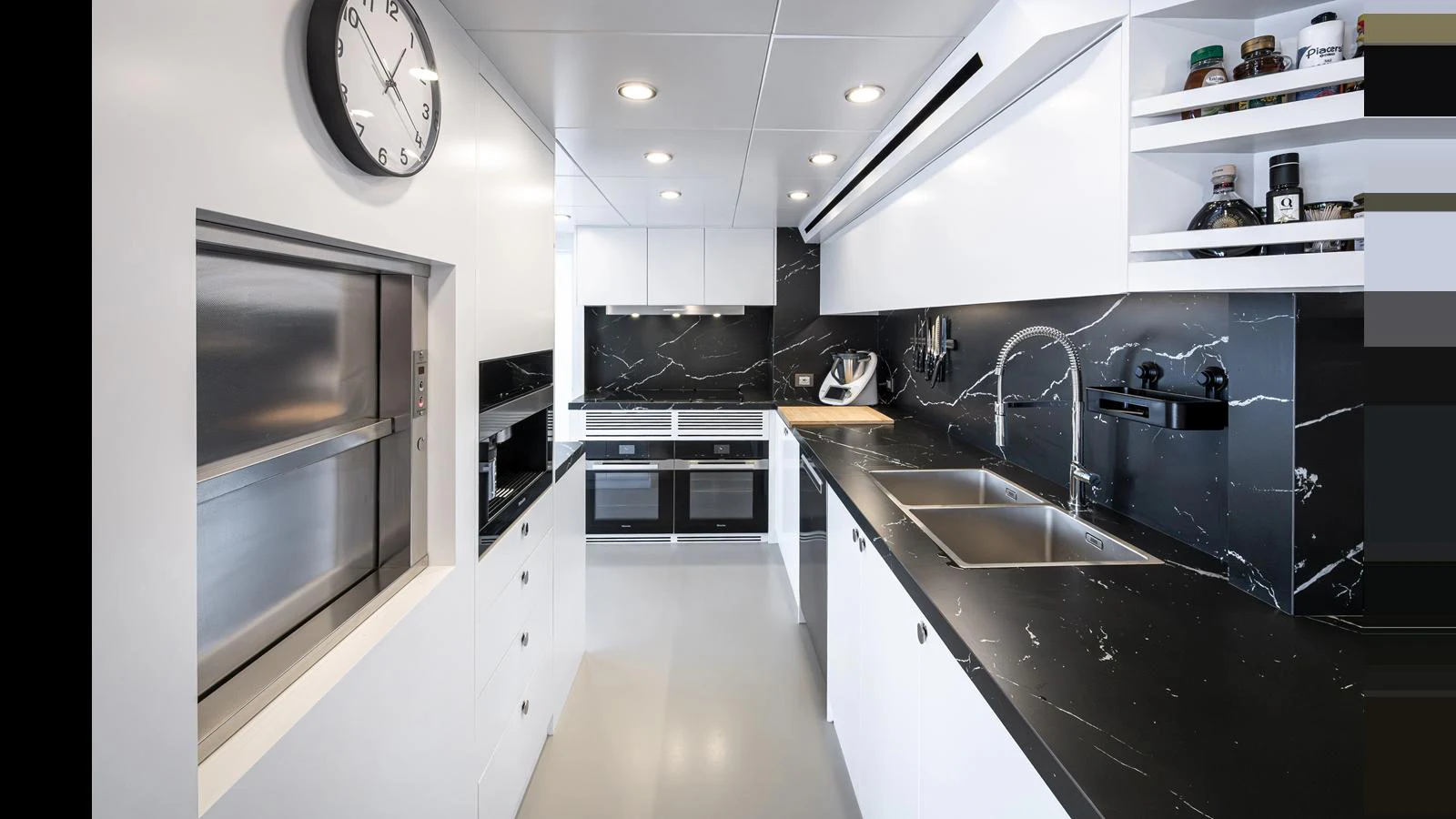 The modern galley features sleek black countertops and state-of-the-art appliances. aboard NUMARINE 37XP-21 Yacht for Sale