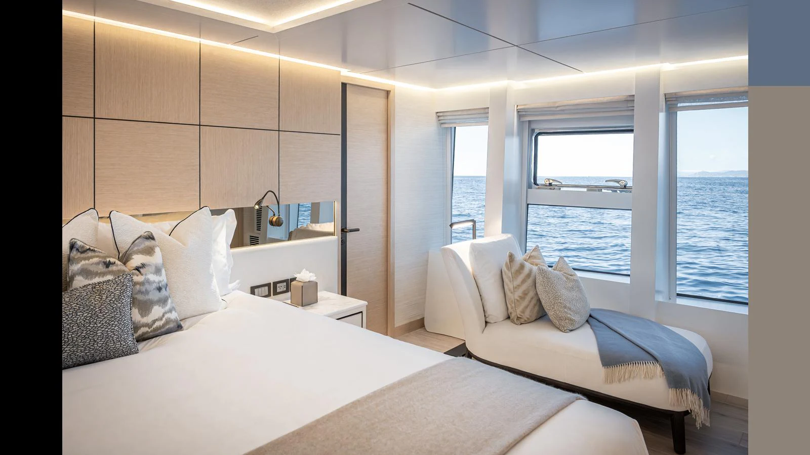 A luxurious stateroom with large windows offering stunning ocean views. aboard NUMARINE 37XP-21 Yacht for Sale