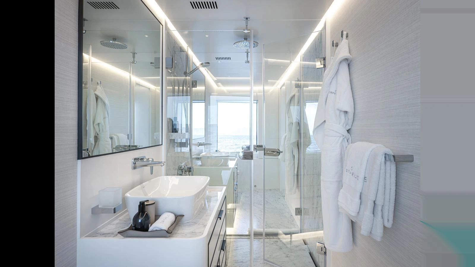 The yacht's bathroom features modern fixtures and a sleek design, with a large mirror and glass shower enclosure. aboard NUMARINE 37XP-21 Yacht for Sale