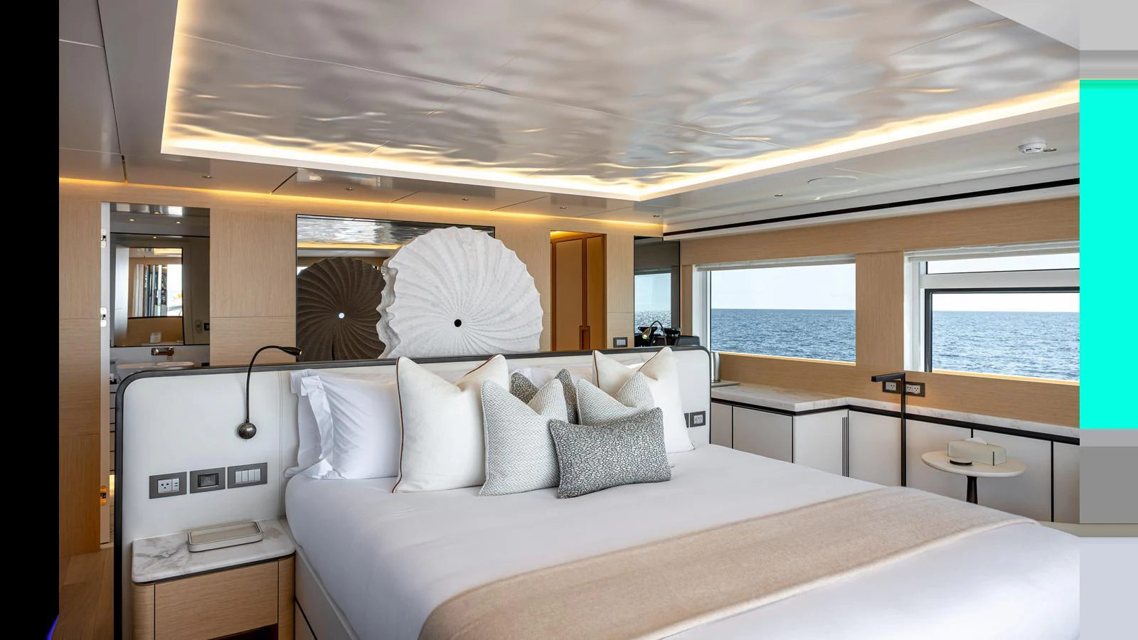A luxurious stateroom with a large bed, modern decor, and ocean views through the windows. aboard NUMARINE 37XP-21 Yacht for Sale