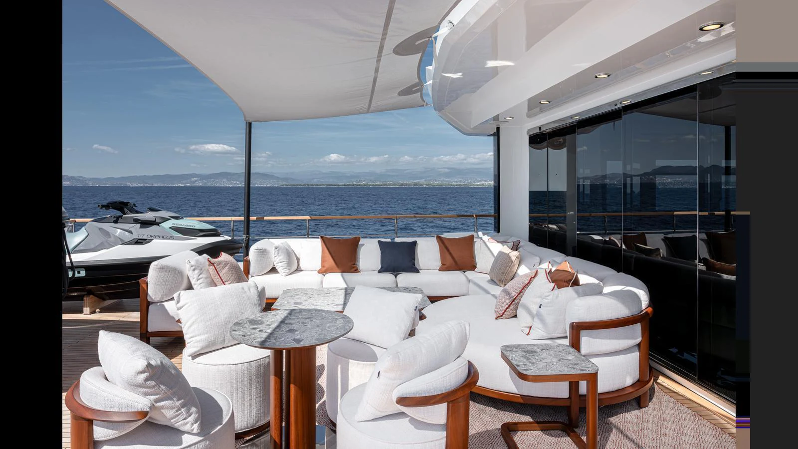 The aft deck features a luxurious seating area with plush white cushions and a stunning ocean view. aboard NUMARINE 37XP-21 Yacht for Sale