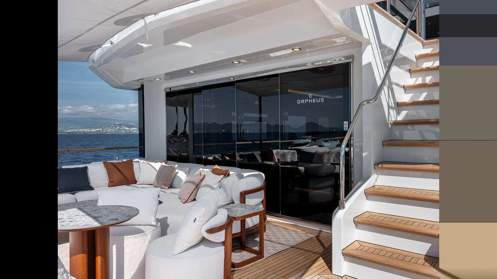 The aft deck features a stylish seating area with plush cushions and a staircase leading to the upper deck. aboard NUMARINE 37XP-21 Yacht for Sale