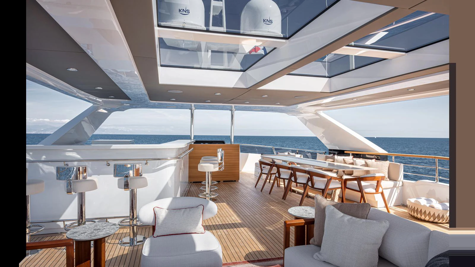 The sundeck features a spacious seating area with modern furnishings and an open view of the sea. aboard NUMARINE 37XP-21 Yacht for Sale