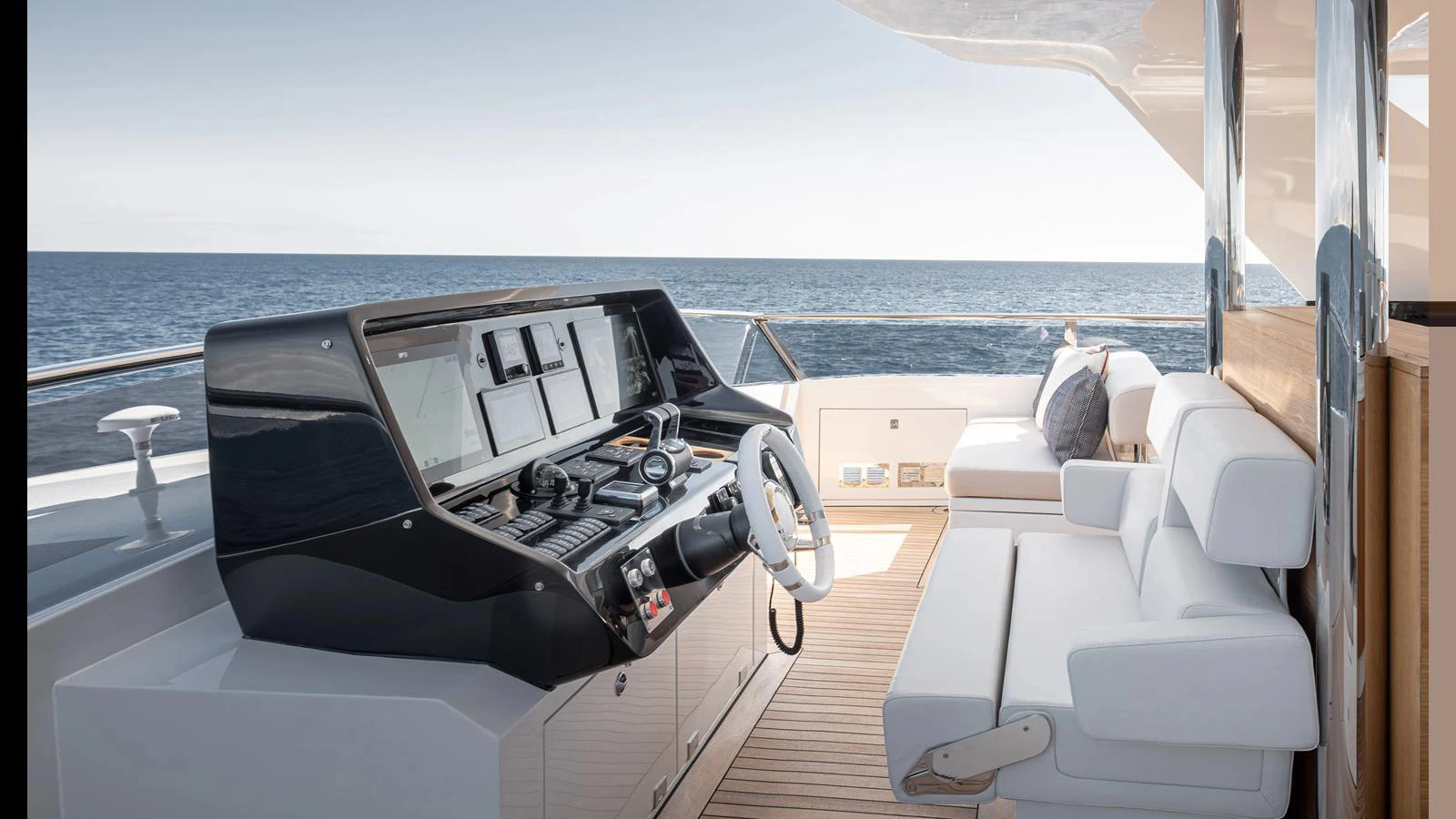 The yacht's helm station offers a sleek and modern control area with comfortable seating and panoramic ocean views. aboard NUMARINE 37XP-21 Yacht for Sale