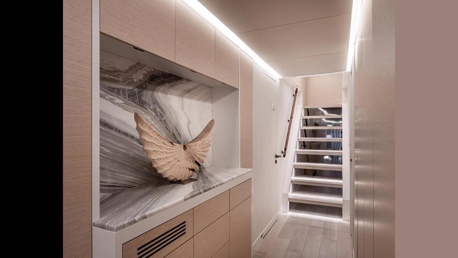 The yacht's interior features a modern hallway with elegant lighting and a decorative sculpture. aboard NUMARINE 37XP-21 Yacht for Sale