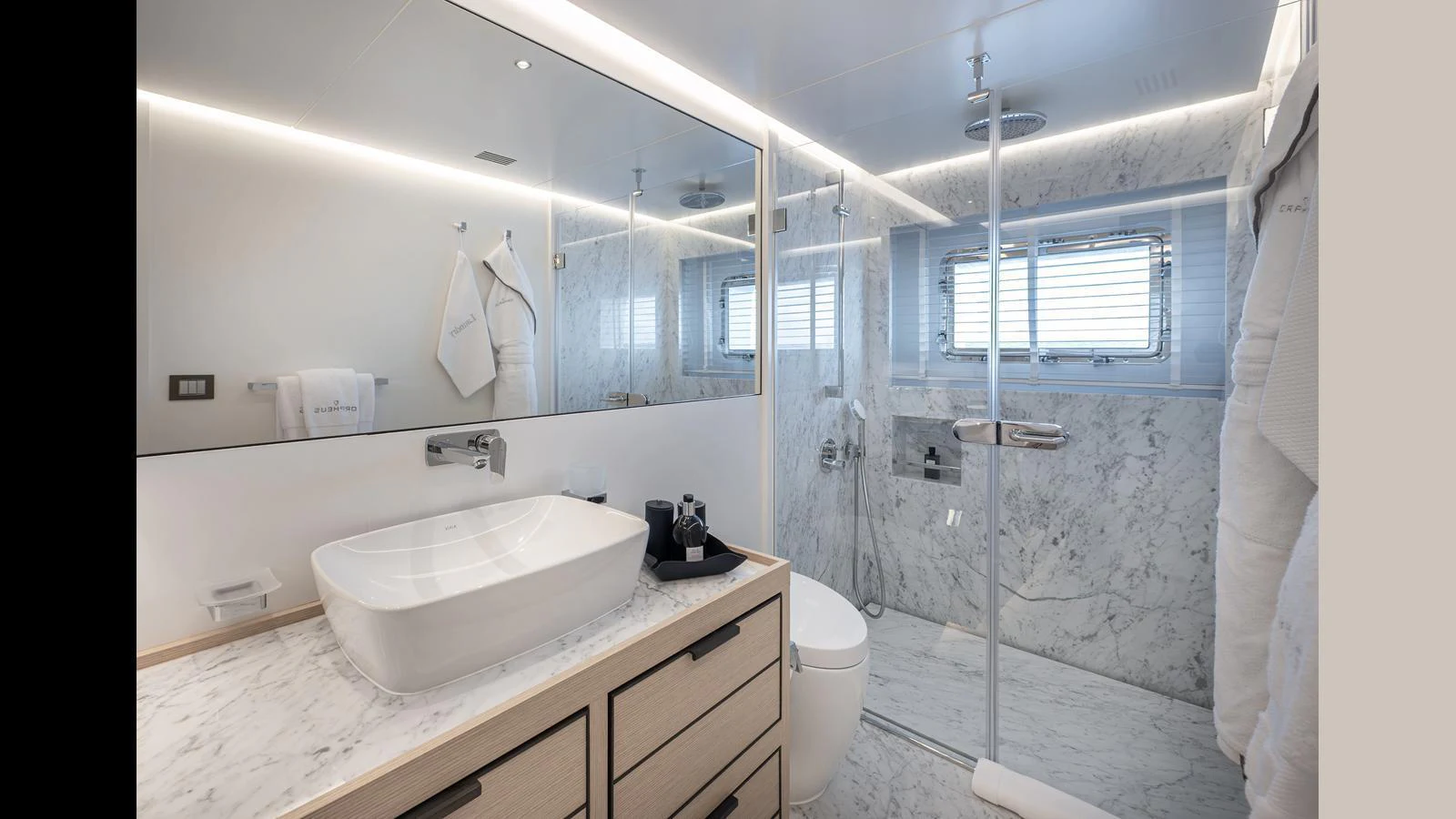 The yacht's bathroom features a modern design with a spacious shower and elegant fixtures. aboard NUMARINE 37XP-21 Yacht for Sale
