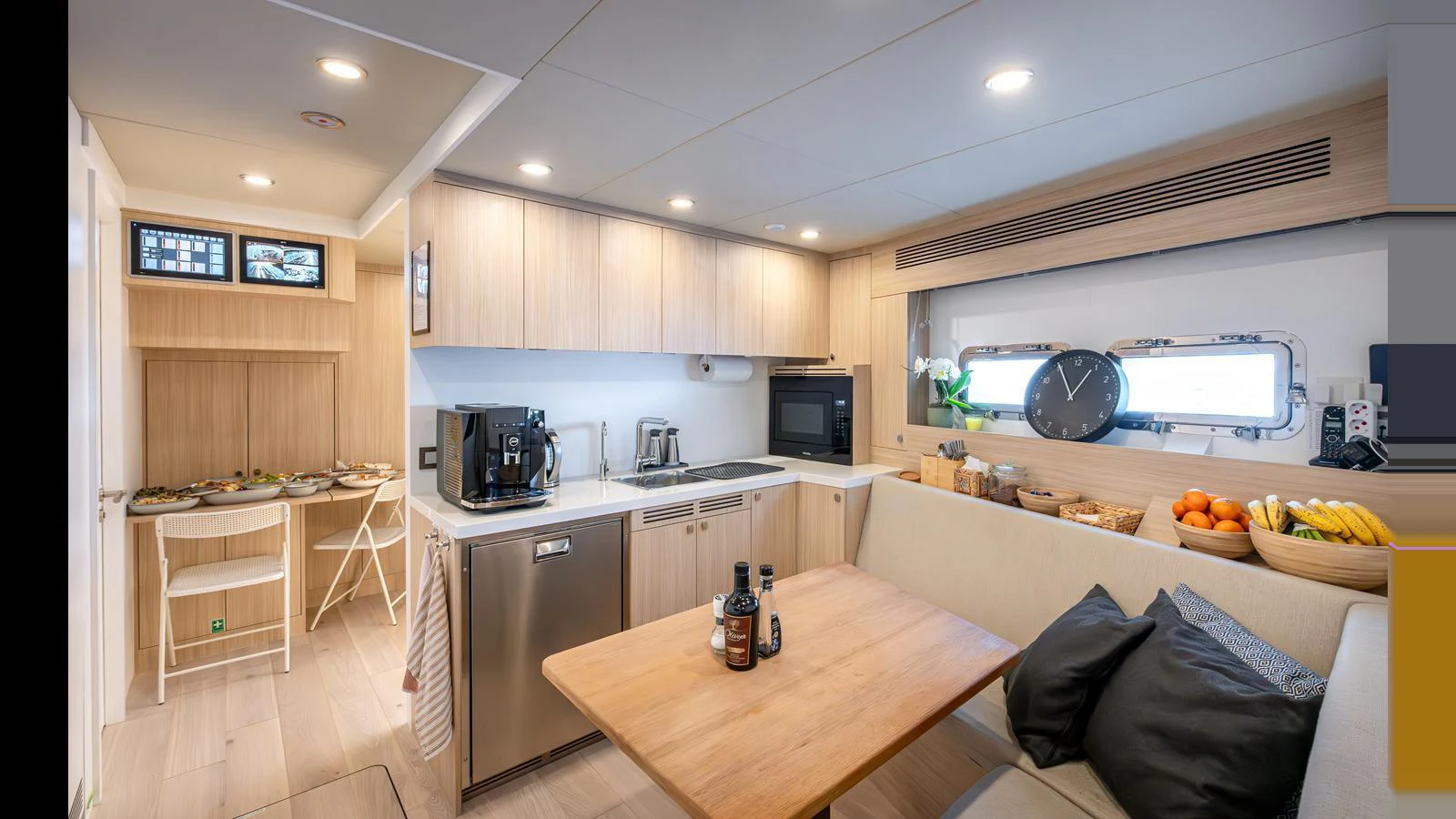 The yacht's galley features modern appliances and a cozy dining area with a sleek, contemporary design. aboard NUMARINE 37XP-21 Yacht for Sale