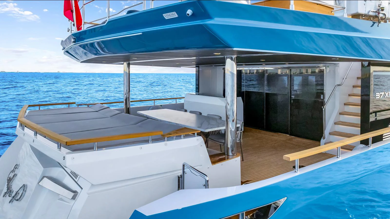 The yacht's aft deck features a spacious lounging area with direct access to the water. aboard NUMARINE 37XP-21 Yacht for Sale