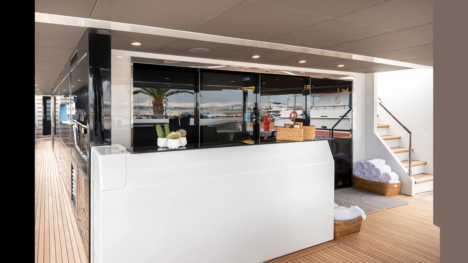The aft deck features a sleek bar area with modern furnishings and a view of the marina. aboard NUMARINE 37XP-21 Yacht for Sale