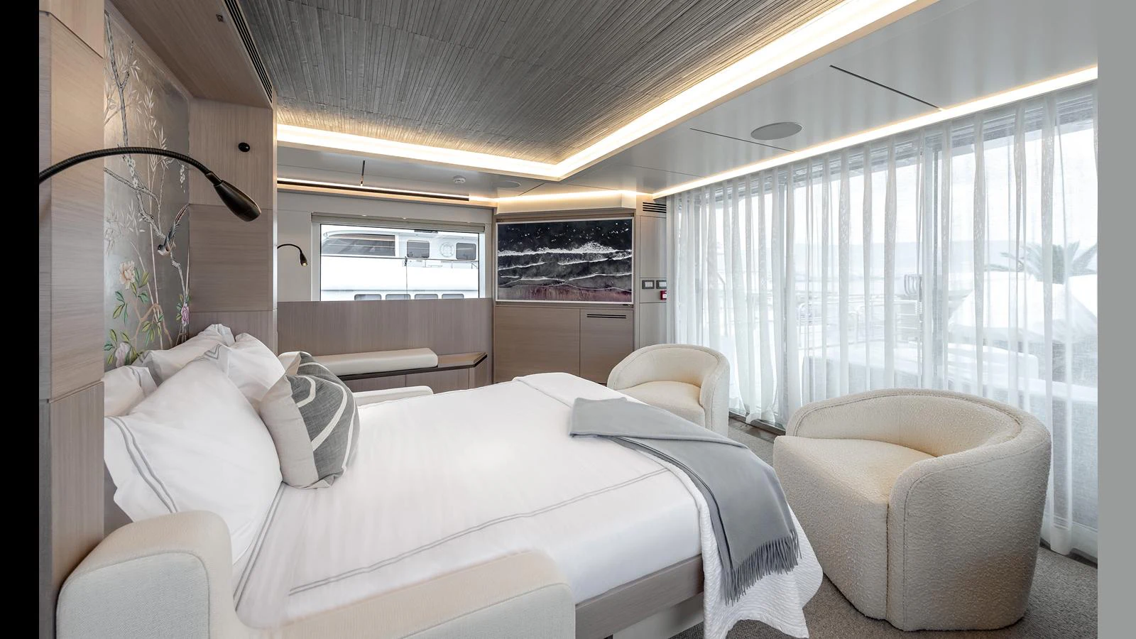 A luxurious stateroom featuring a large bed, comfortable seating, and ample natural light. aboard NUMARINE 37XP-21 Yacht for Sale