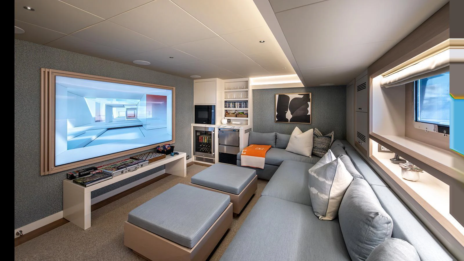 The yacht's lounge area features a large screen, comfortable seating, and modern decor. aboard NUMARINE 37XP-21 Yacht for Sale