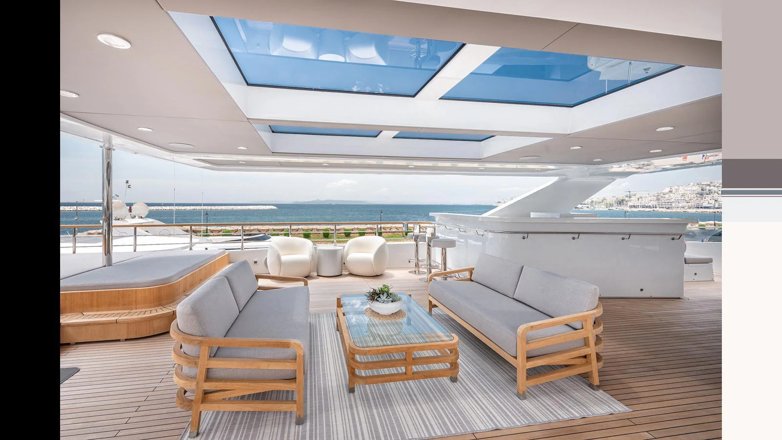 The aft deck features a stylish seating area with panoramic views and a skylight. aboard NUMARINE 37XP-21 Yacht for Sale