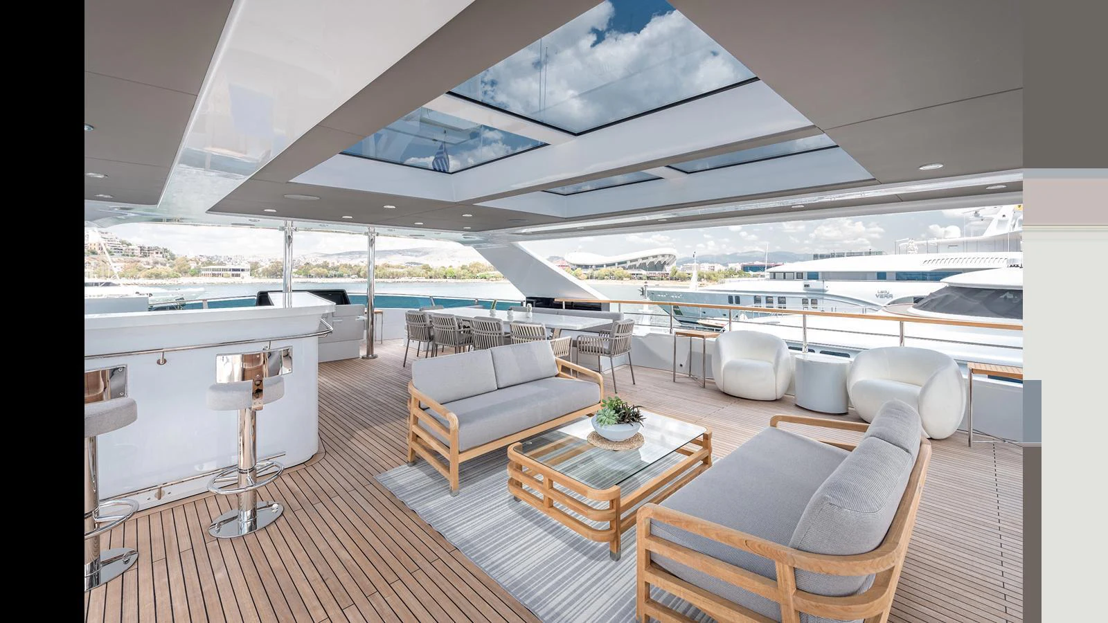 The aft deck features a spacious and stylish outdoor lounge area with comfortable seating and a bar. aboard NUMARINE 37XP-21 Yacht for Sale