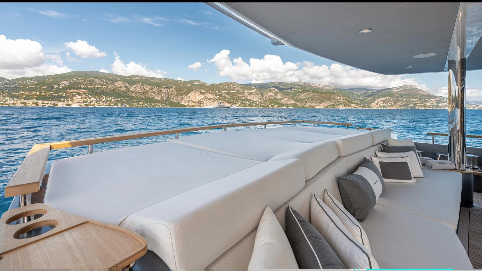The sundeck offers a luxurious lounging area with plush cushions and scenic views of the surrounding waters and mountains. aboard NUMARINE 37XP-21 Yacht for Sale