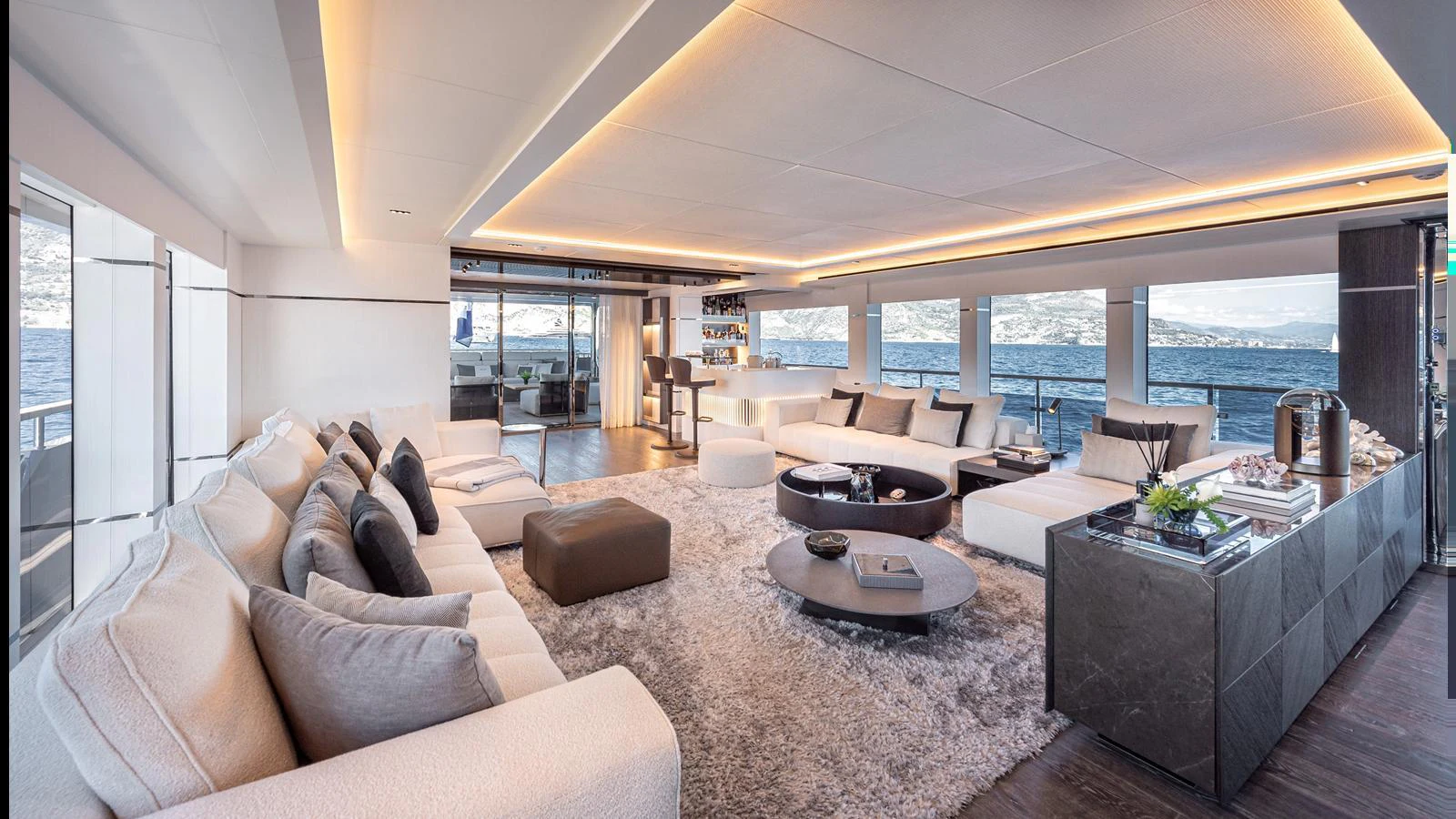 The spacious salon features luxurious seating, modern decor, and expansive windows offering stunning sea views. aboard NUMARINE 37XP-21 Yacht for Sale