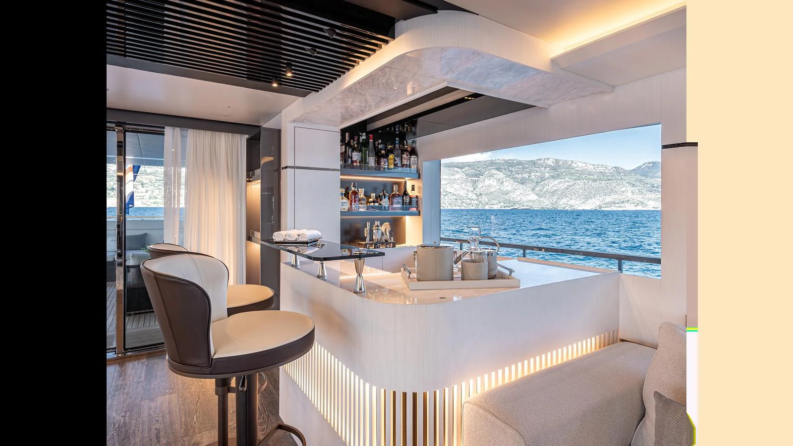 The yacht's interior features a stylish bar area with a scenic ocean view. aboard NUMARINE 37XP-21 Yacht for Sale