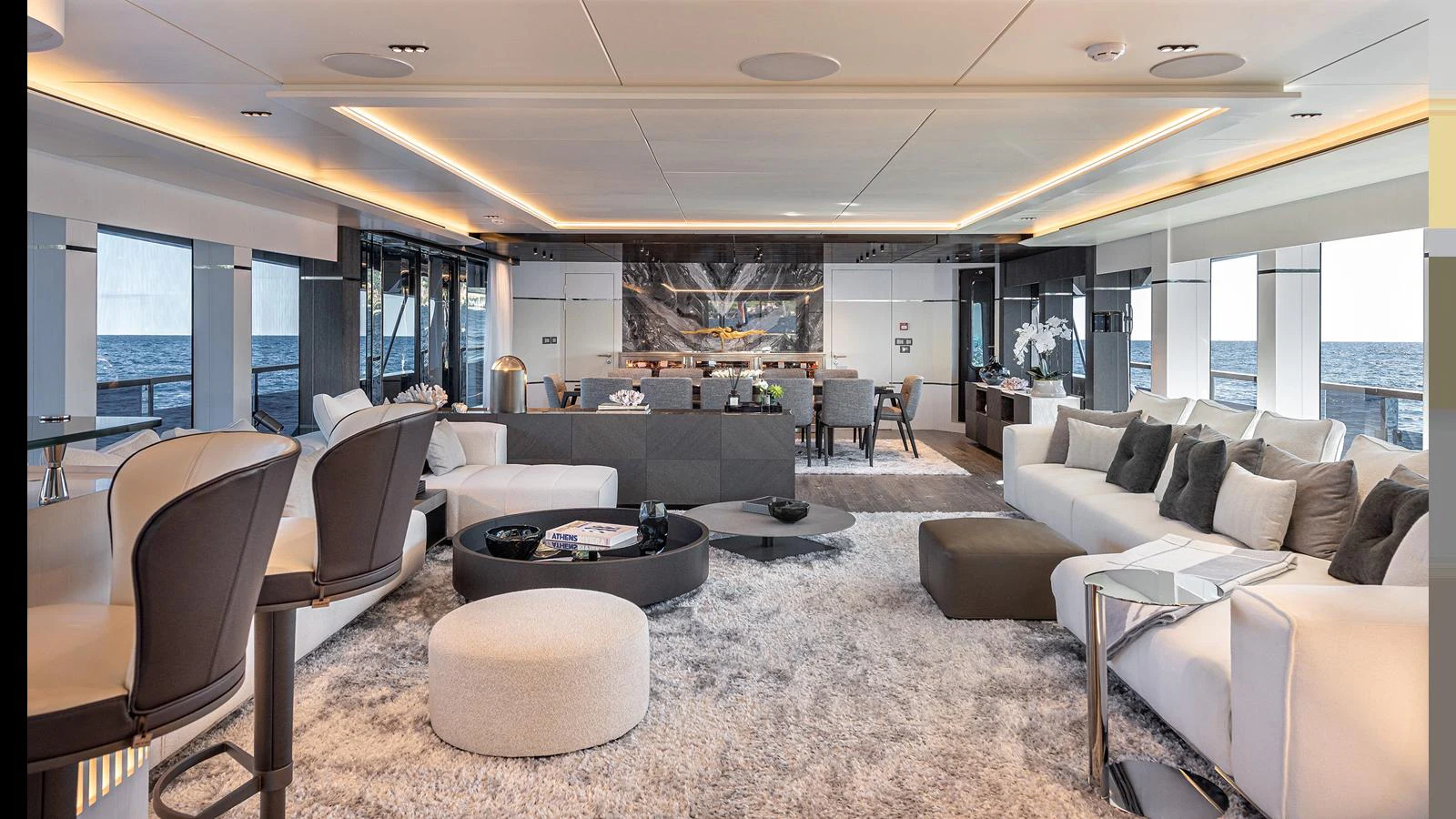The salon features a spacious and elegantly designed seating area with modern furnishings and panoramic ocean views. aboard NUMARINE 37XP-21 Yacht for Sale