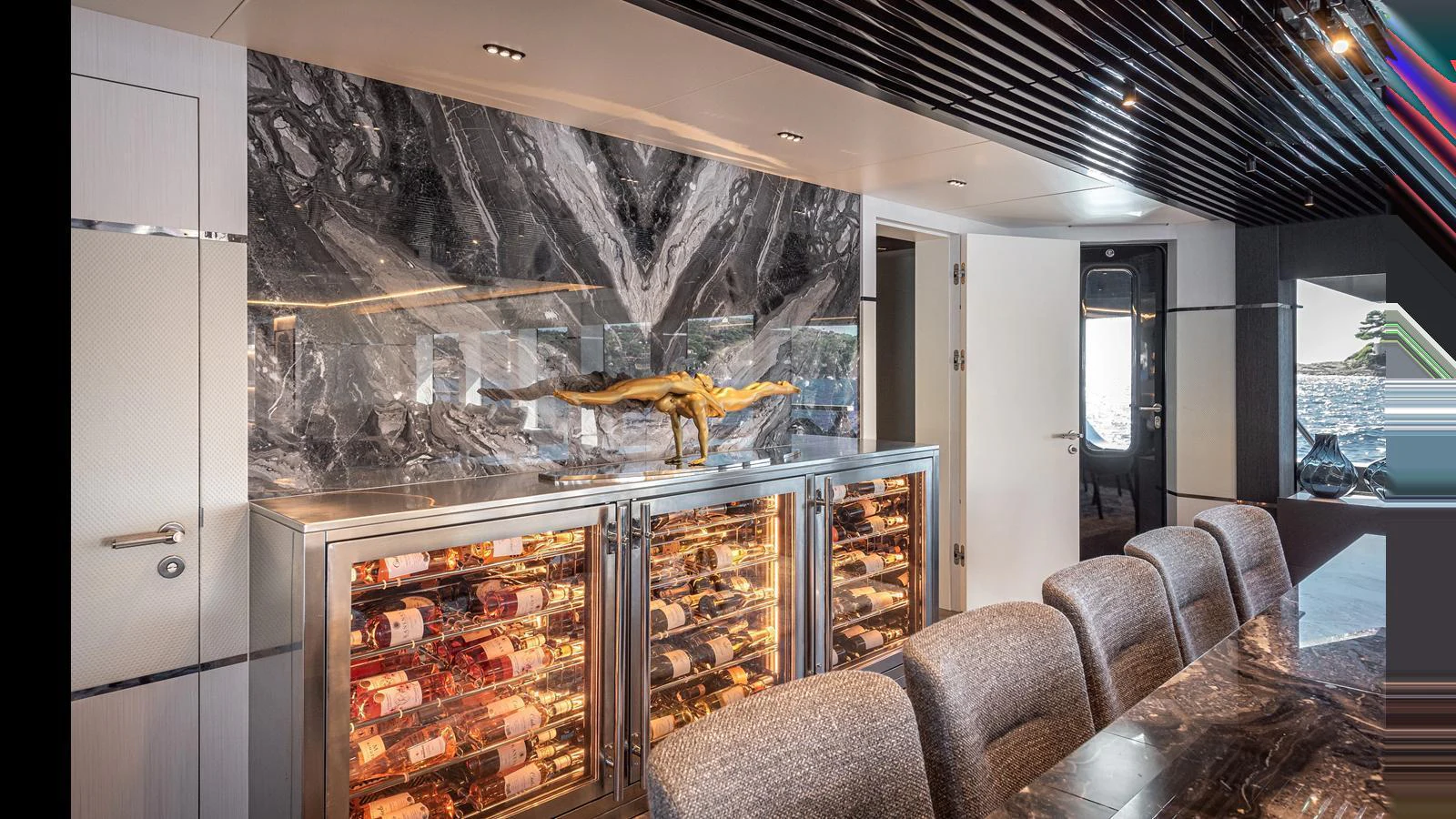 The yacht's dining area features a sophisticated wine storage display and luxurious seating. aboard NUMARINE 37XP-21 Yacht for Sale