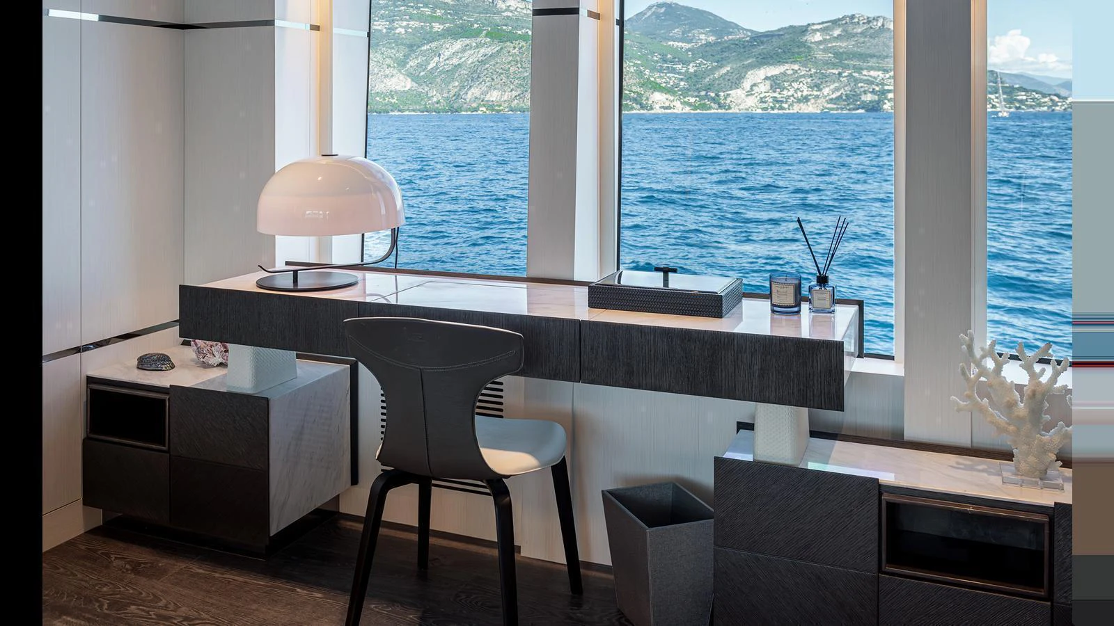 A stylish office space with a view of the sea, featuring modern furnishings and decor. aboard NUMARINE 37XP-21 Yacht for Sale