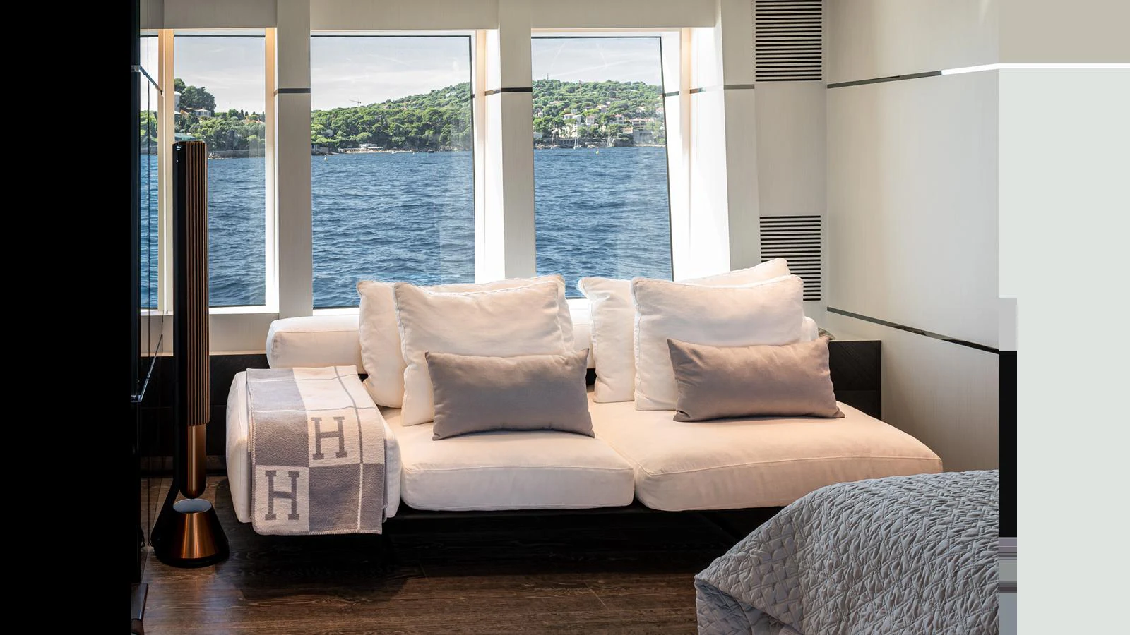 A luxurious stateroom with a comfortable seating area and large windows offering a scenic view of the water. aboard NUMARINE 37XP-21 Yacht for Sale