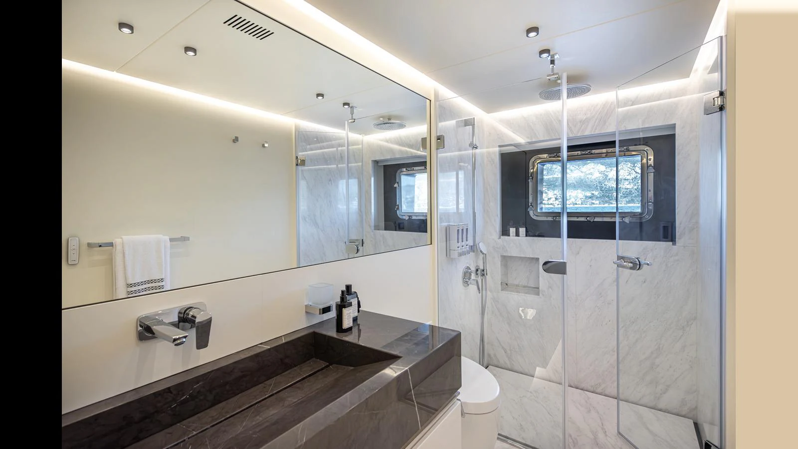 The yacht's bathroom features a sleek design with a large mirror, modern fixtures, and a spacious shower area. aboard NUMARINE 37XP-21 Yacht for Sale