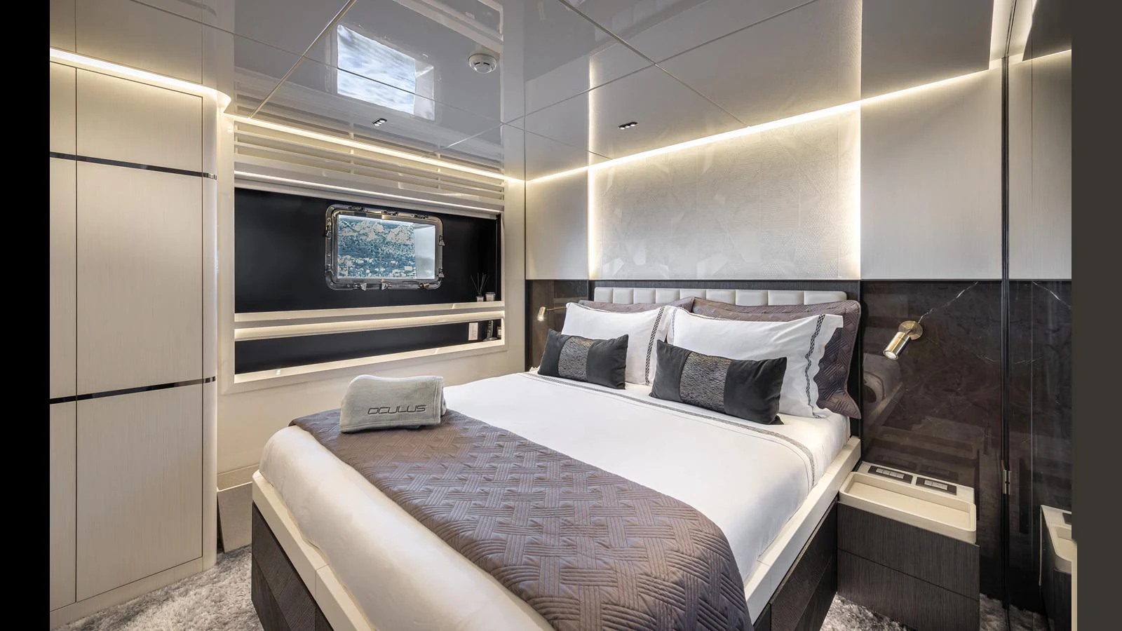 A luxurious stateroom featuring a plush bed with elegant bedding and modern lighting. aboard NUMARINE 37XP-21 Yacht for Sale
