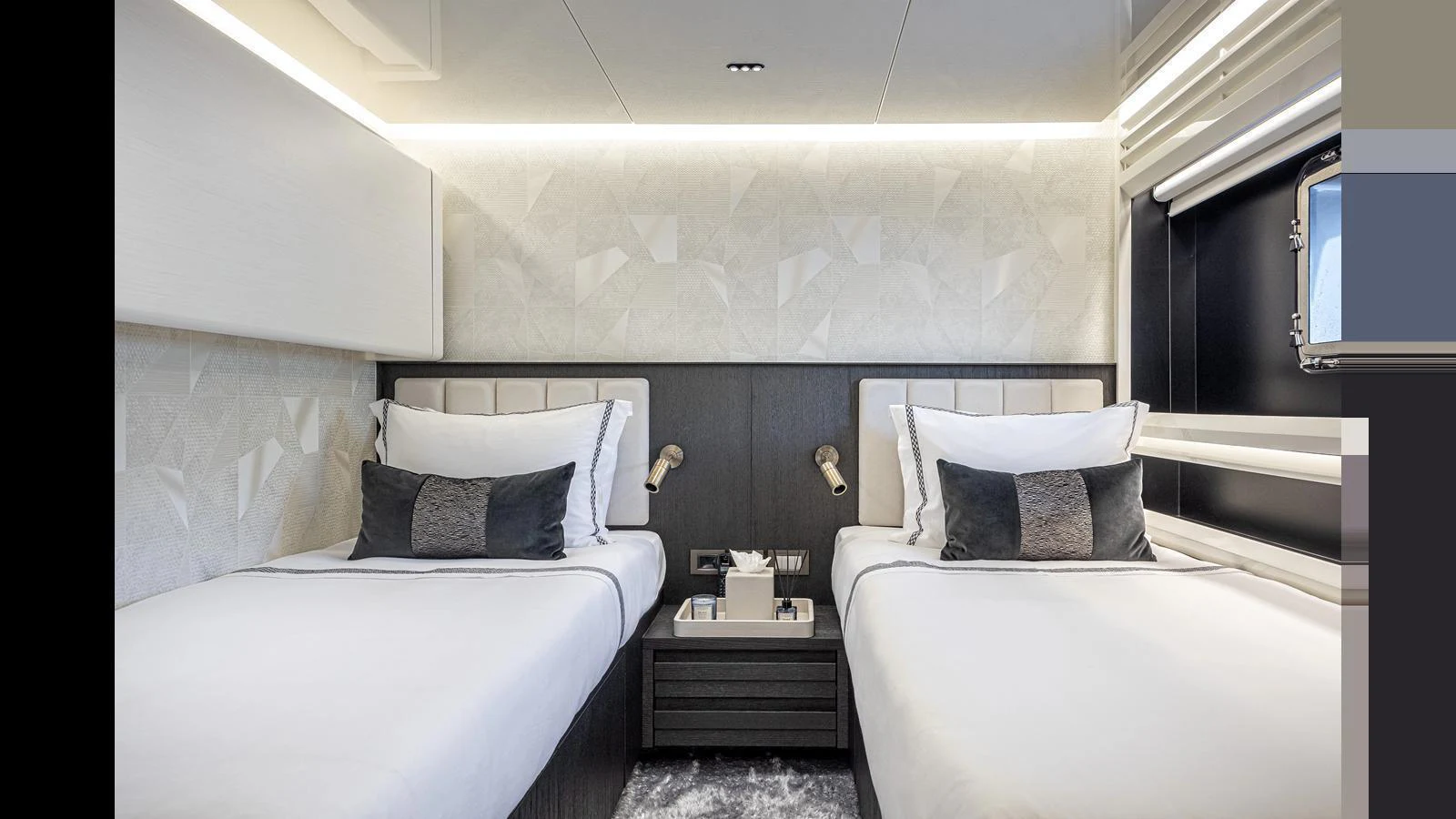 The guest stateroom features twin beds with modern decor and ample lighting. aboard NUMARINE 37XP-21 Yacht for Sale