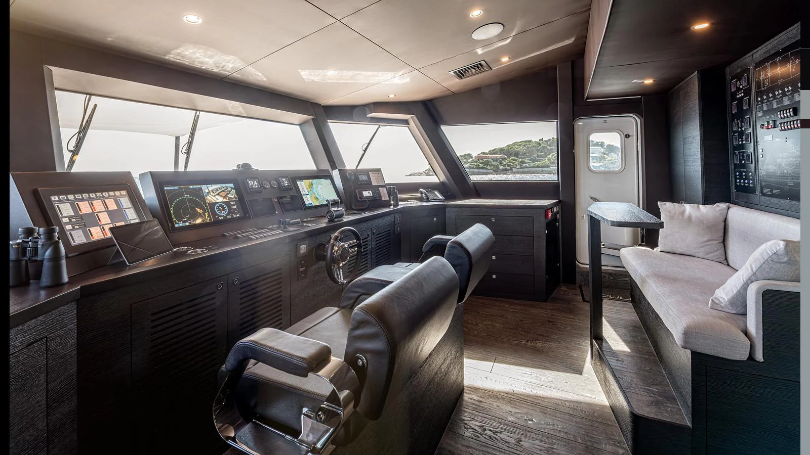 The helm station features advanced navigation equipment and comfortable seating with a view of the surrounding waters. aboard NUMARINE 37XP-21 Yacht for Sale