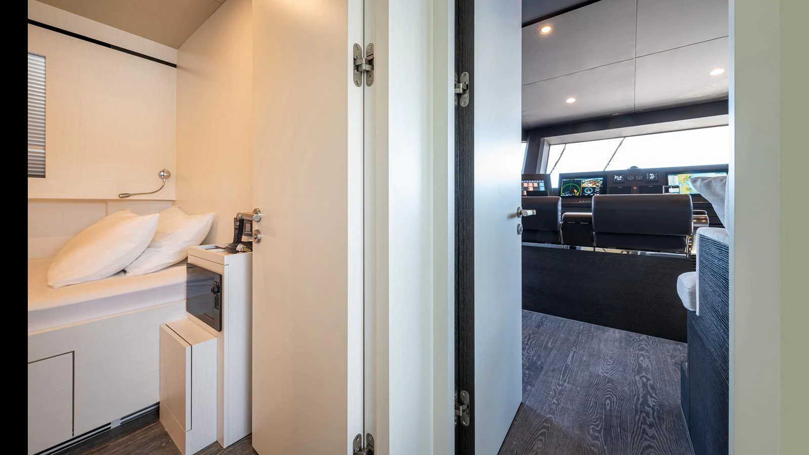 The image showcases a cozy cabin leading to a modern helm station with advanced navigation equipment. aboard NUMARINE 37XP-21 Yacht for Sale