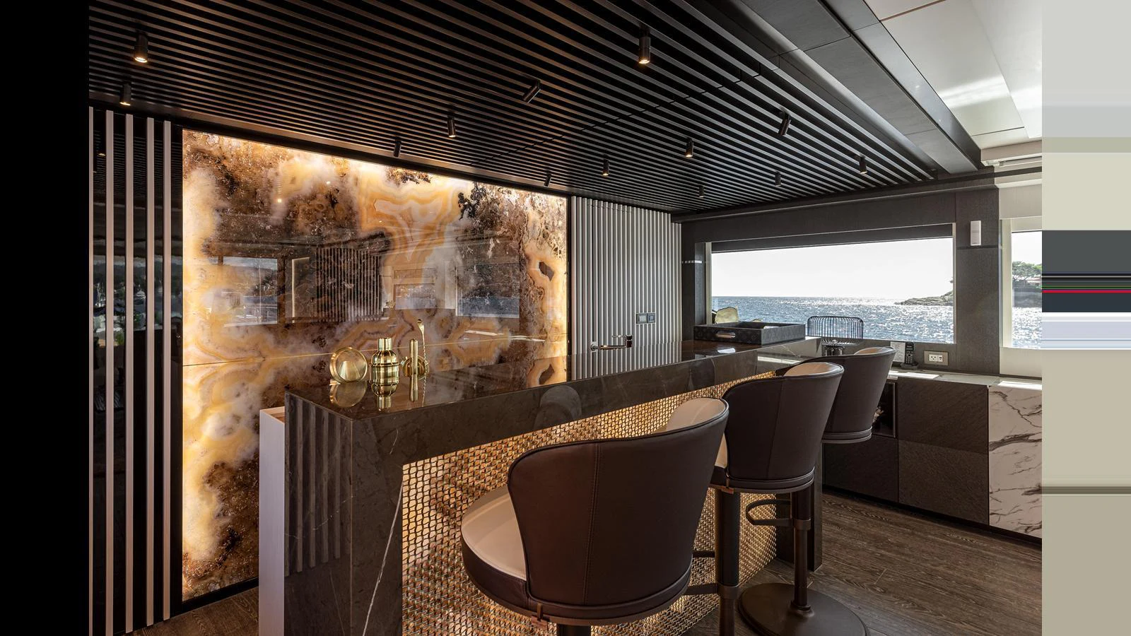 The yacht's interior bar area features luxurious seating and a stunning backlit onyx wall. aboard NUMARINE 37XP-21 Yacht for Sale