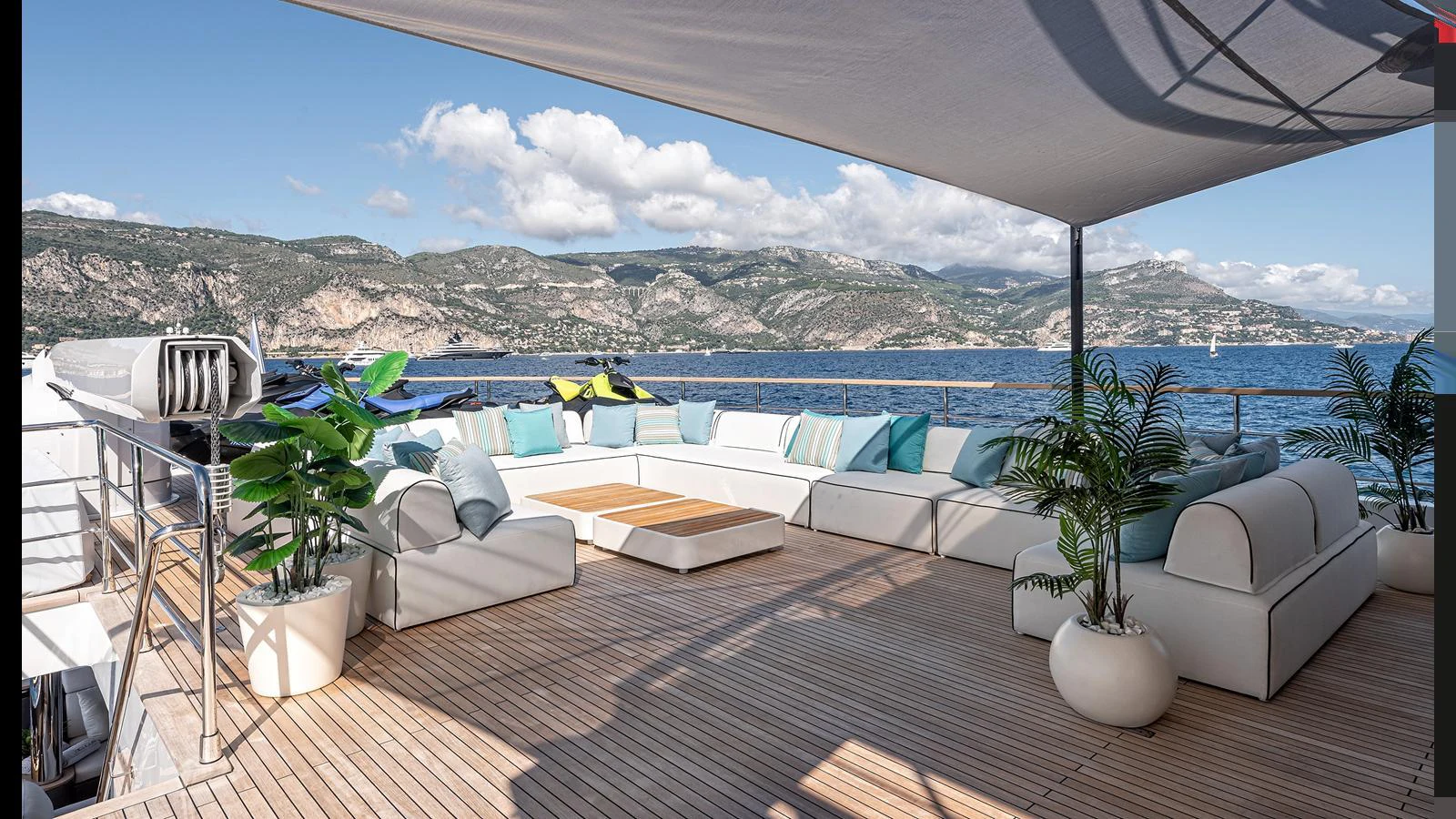 The sundeck features a spacious seating area with plush cushions, shaded by a canopy, and offers stunning views of the surrounding landscape. aboard NUMARINE 37XP-21 Yacht for Sale