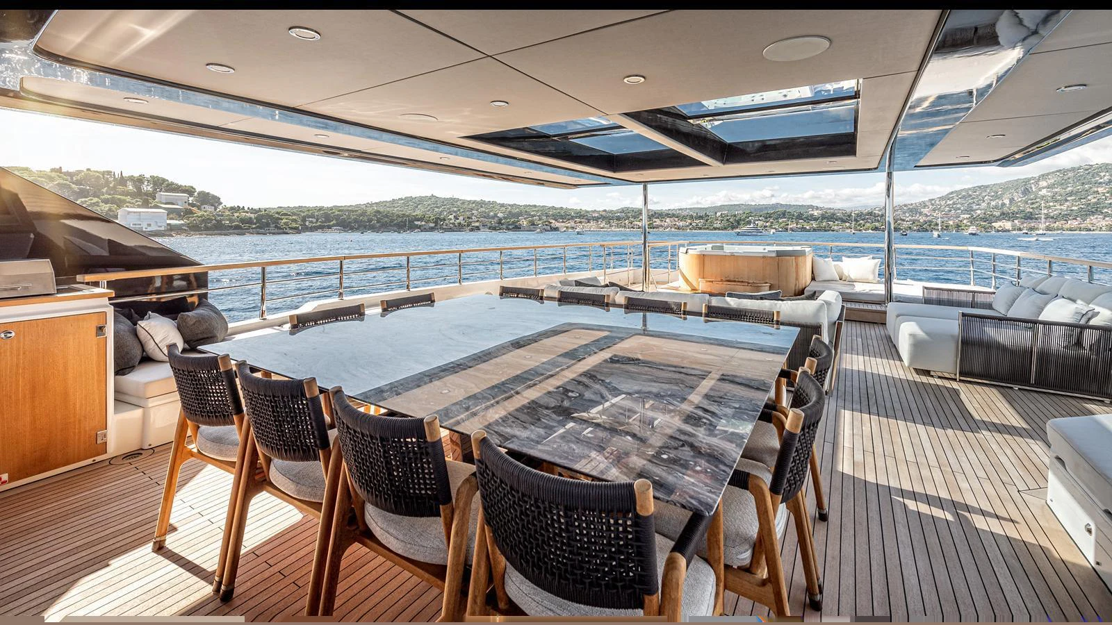 The aft deck offers a spacious and elegant dining area with panoramic views of the sea. aboard NUMARINE 37XP-21 Yacht for Sale