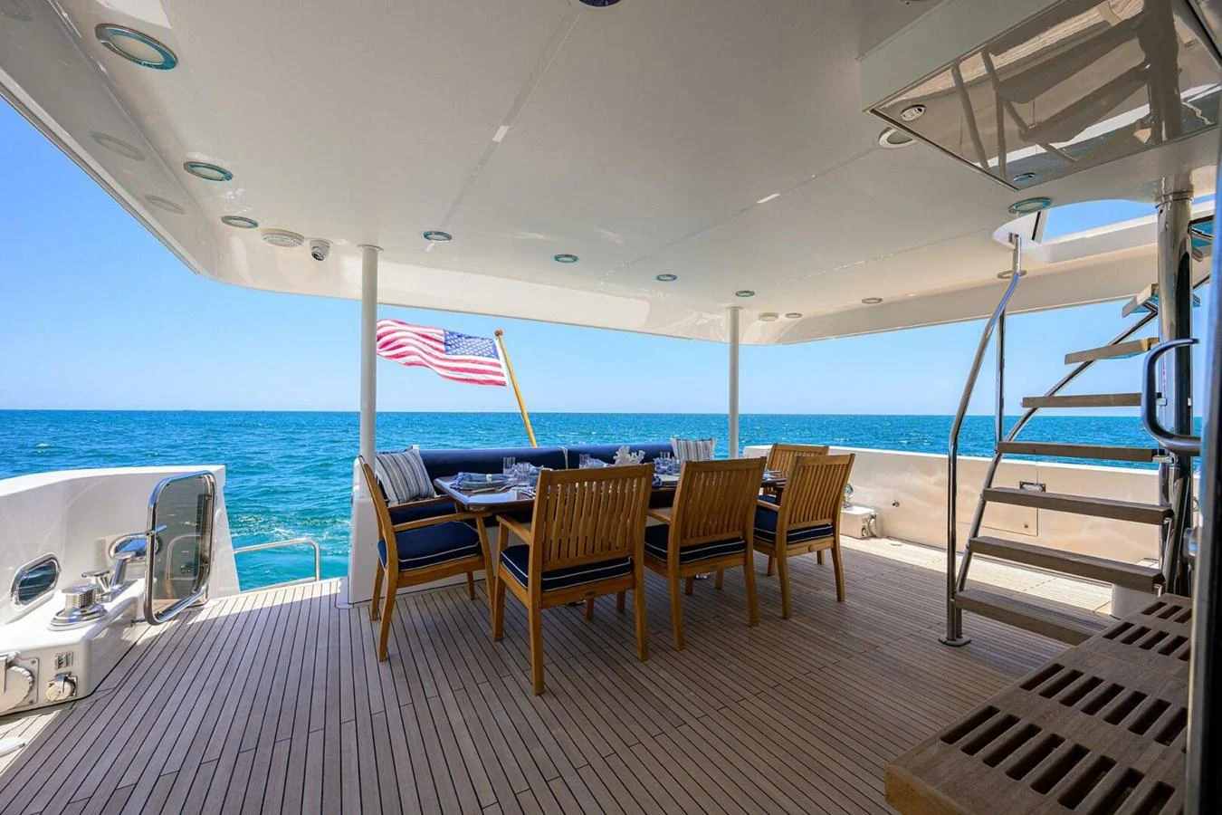 a deck with chairs and tables on it aboard JULE Yacht for Sale
