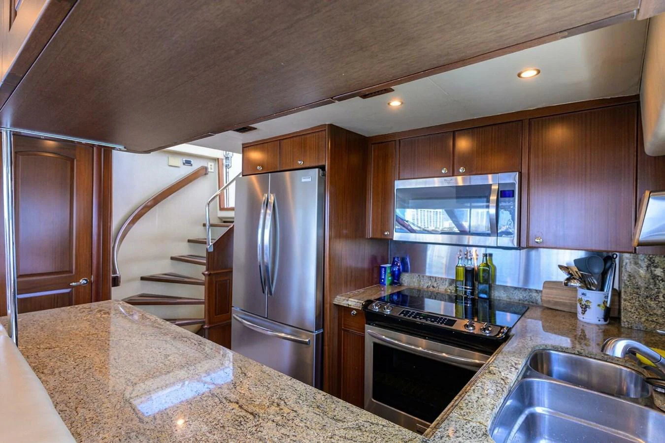 a kitchen with a stainless steel refrigerator aboard JULE Yacht for Sale
