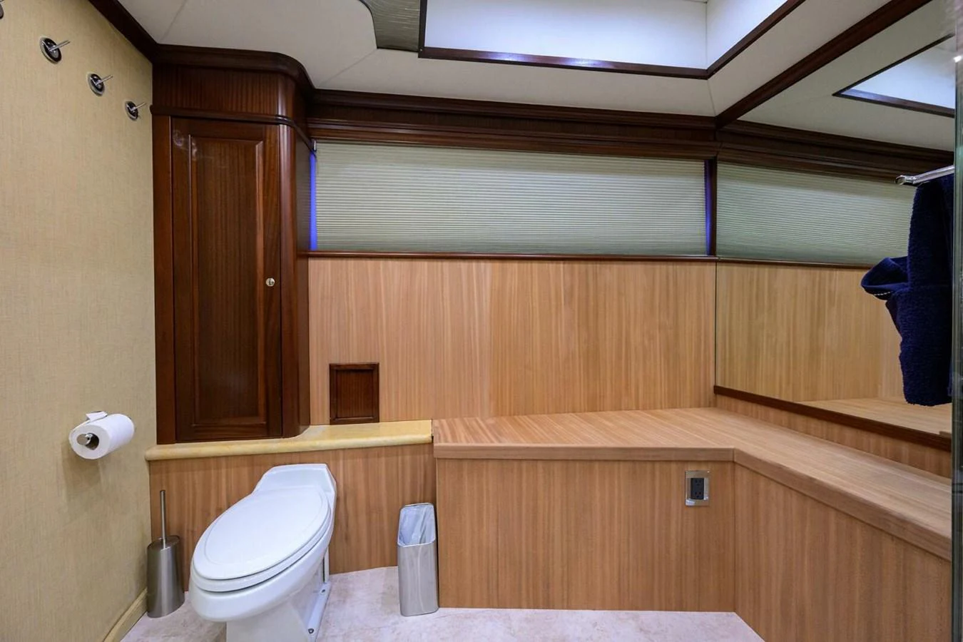 a bathroom with wooden cabinets aboard JULE Yacht for Sale